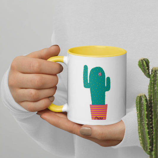 White ceramic mug with cactus print and yellow interior