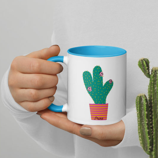White ceramic mug with cactus graphic, blue interior rim and handle